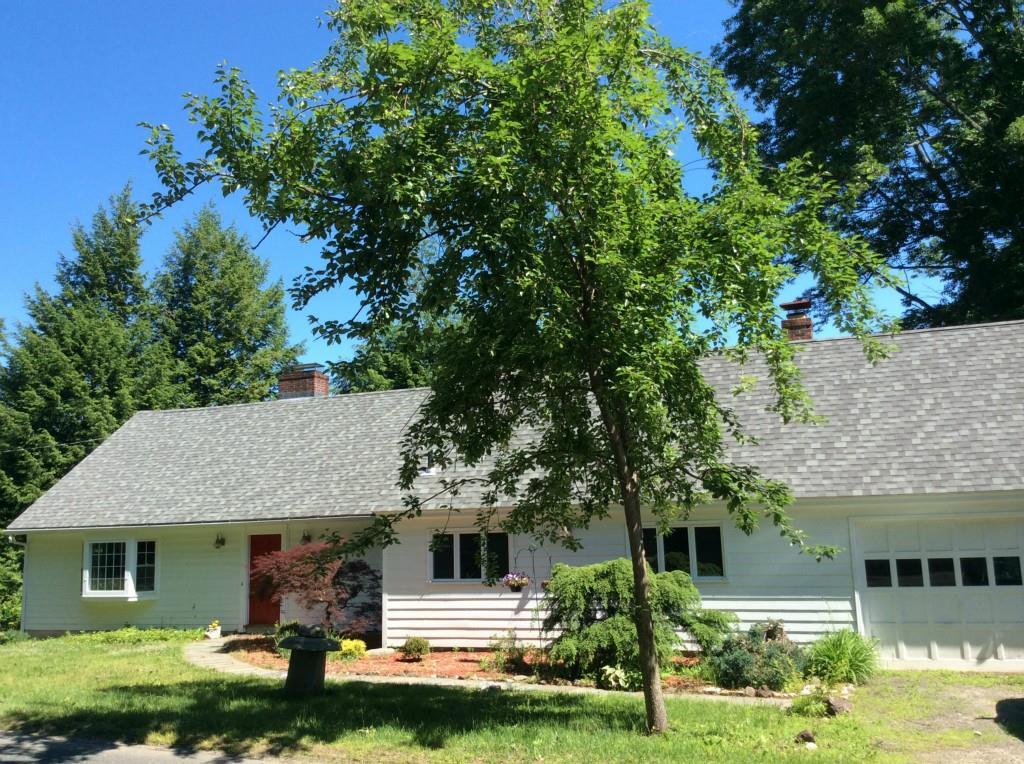 13 White Deer Rocks Road Woodbury, CT 06798 - Photo 1 of 1 a front view of a house with a yard garage and outdoor seating