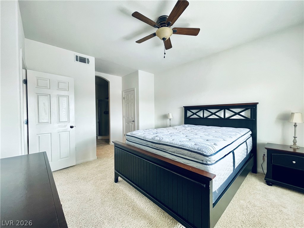 7701 West Robindale Road, Unit 206 Las Vegas, NV 89113 - Photo 14 of 30 Soft carpeting underfoot defines this inviting bedroom suite with classic paneled doors.