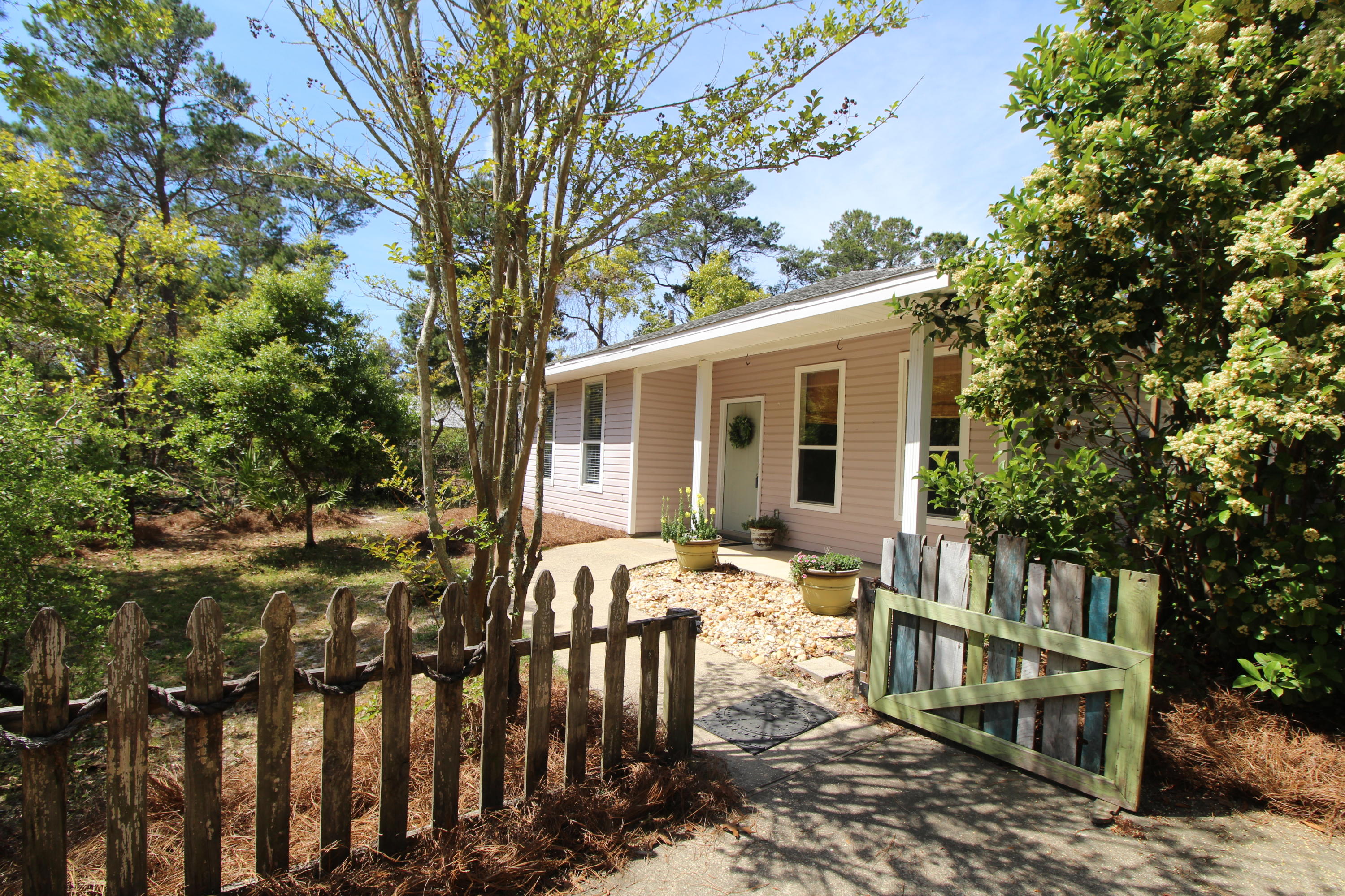 91 Walnut Street Santa Rosa Beach, FL 32459 - Photo 1 of 39 a view of a house with backyard and sitting area