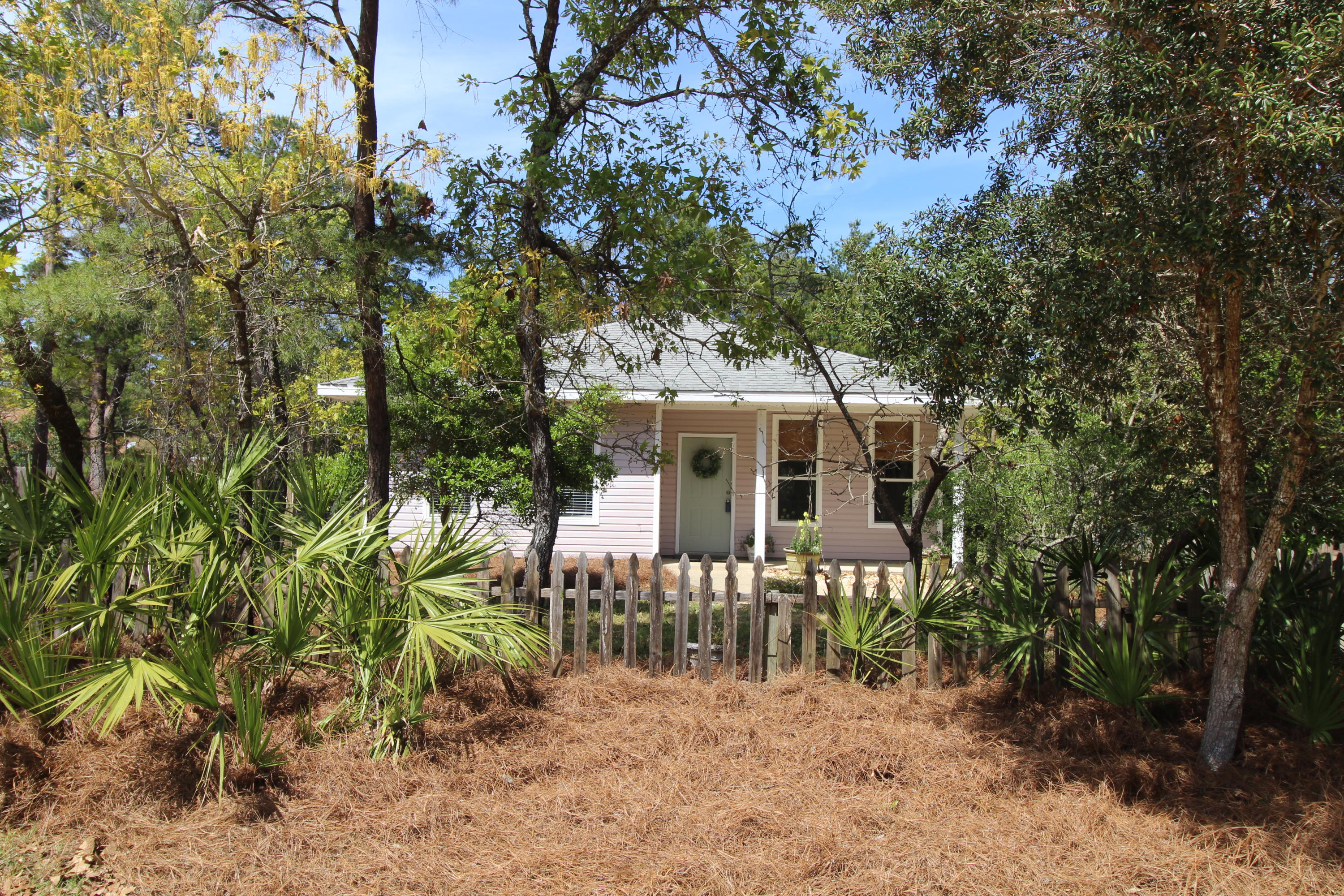 91 Walnut Street Santa Rosa Beach, FL 32459 - Photo 2 of 39 a front view of a house with a garden