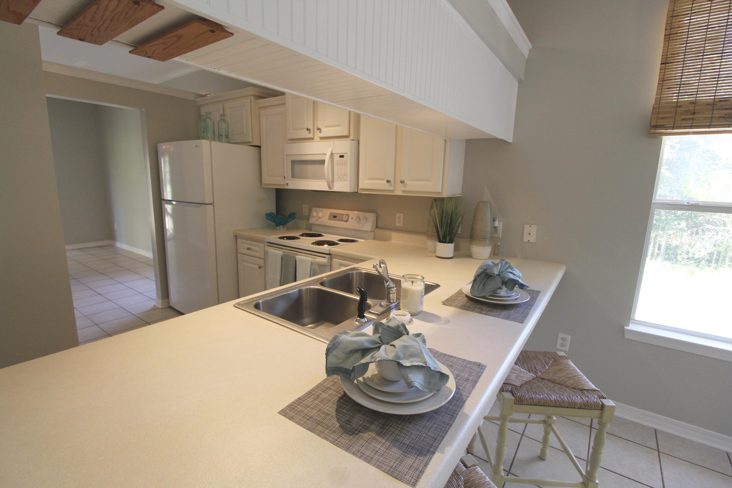 91 Walnut Street Santa Rosa Beach, FL 32459 - Photo 12 of 39 a kitchen with a refrigerator and wooden floor