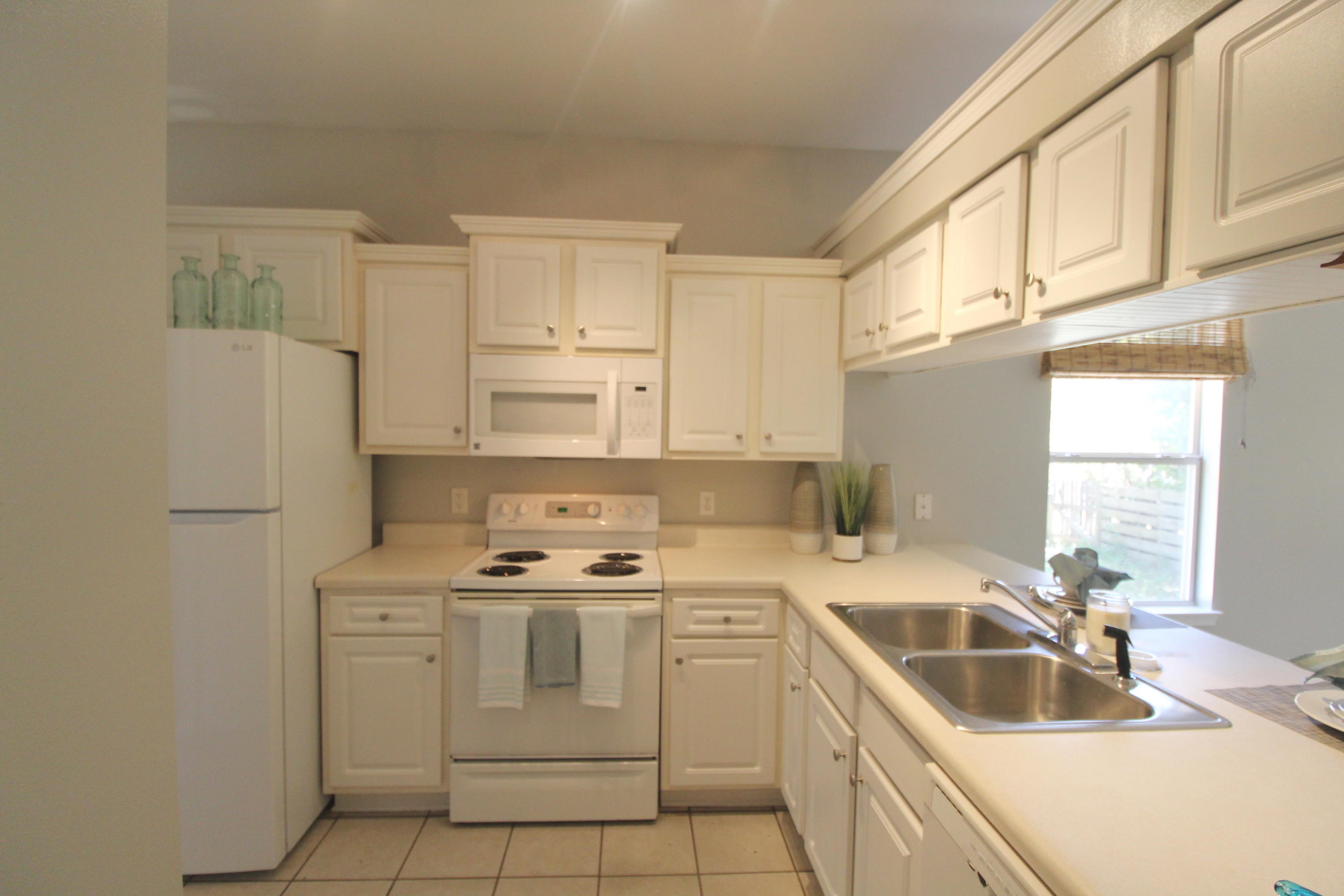 91 Walnut Street Santa Rosa Beach, FL 32459 - Photo 15 of 39 a kitchen that has a sink cabinets counter space and appliances