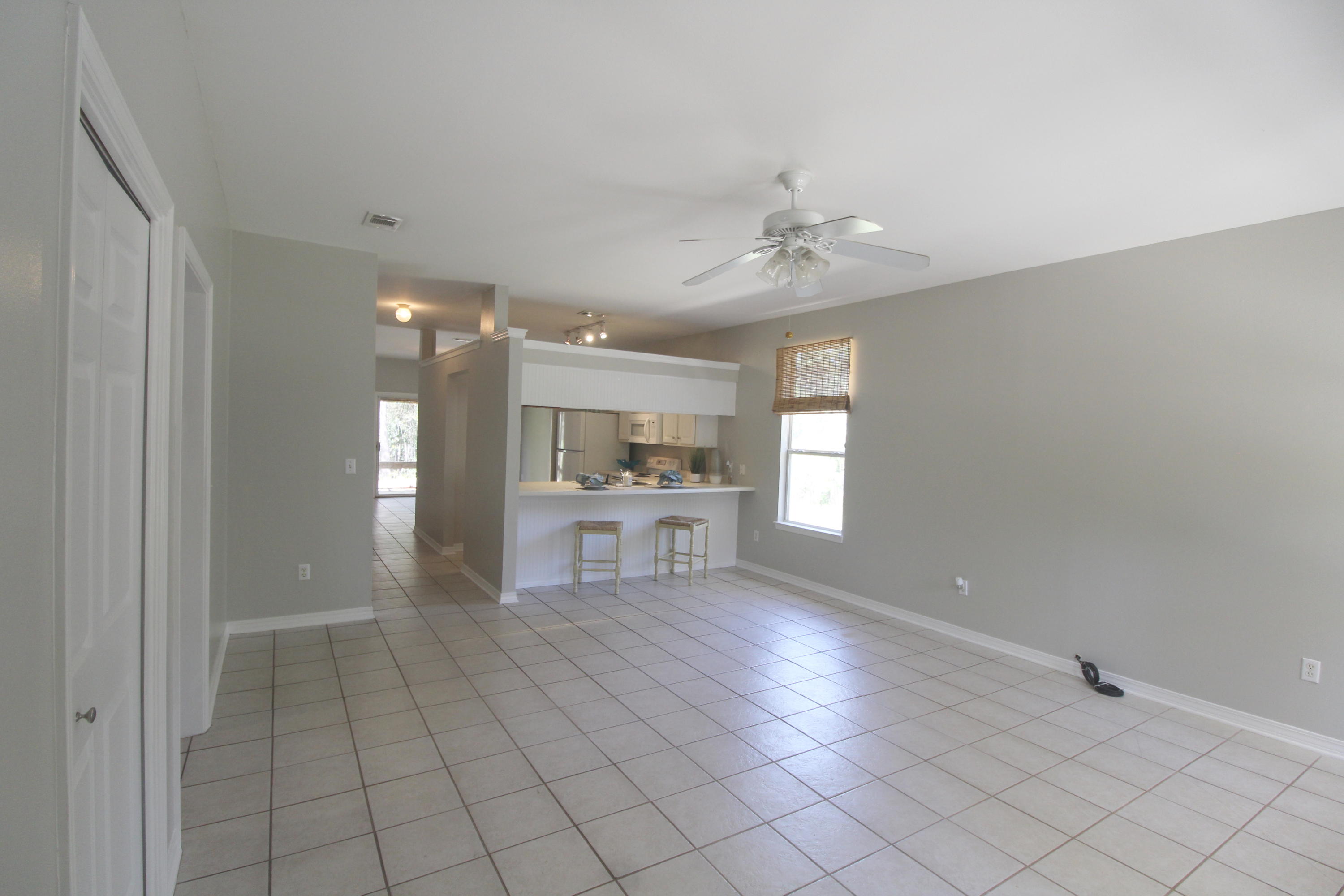 91 Walnut Street Santa Rosa Beach, FL 32459 - Photo 16 of 39 a view of open kitchen with a sink and dishwasher with white walls