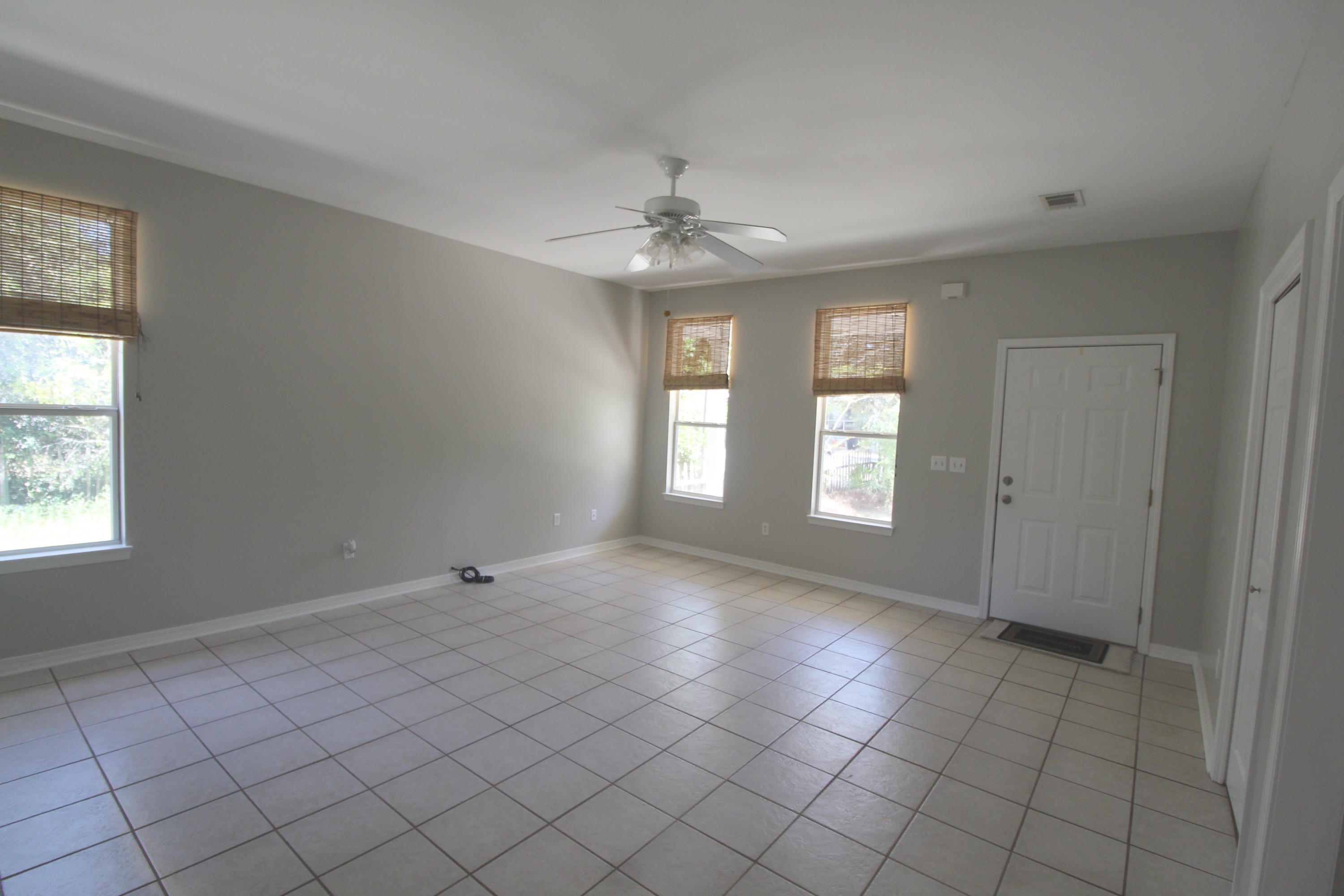 91 Walnut Street Santa Rosa Beach, FL 32459 - Photo 17 of 39 an empty room with windows and fan