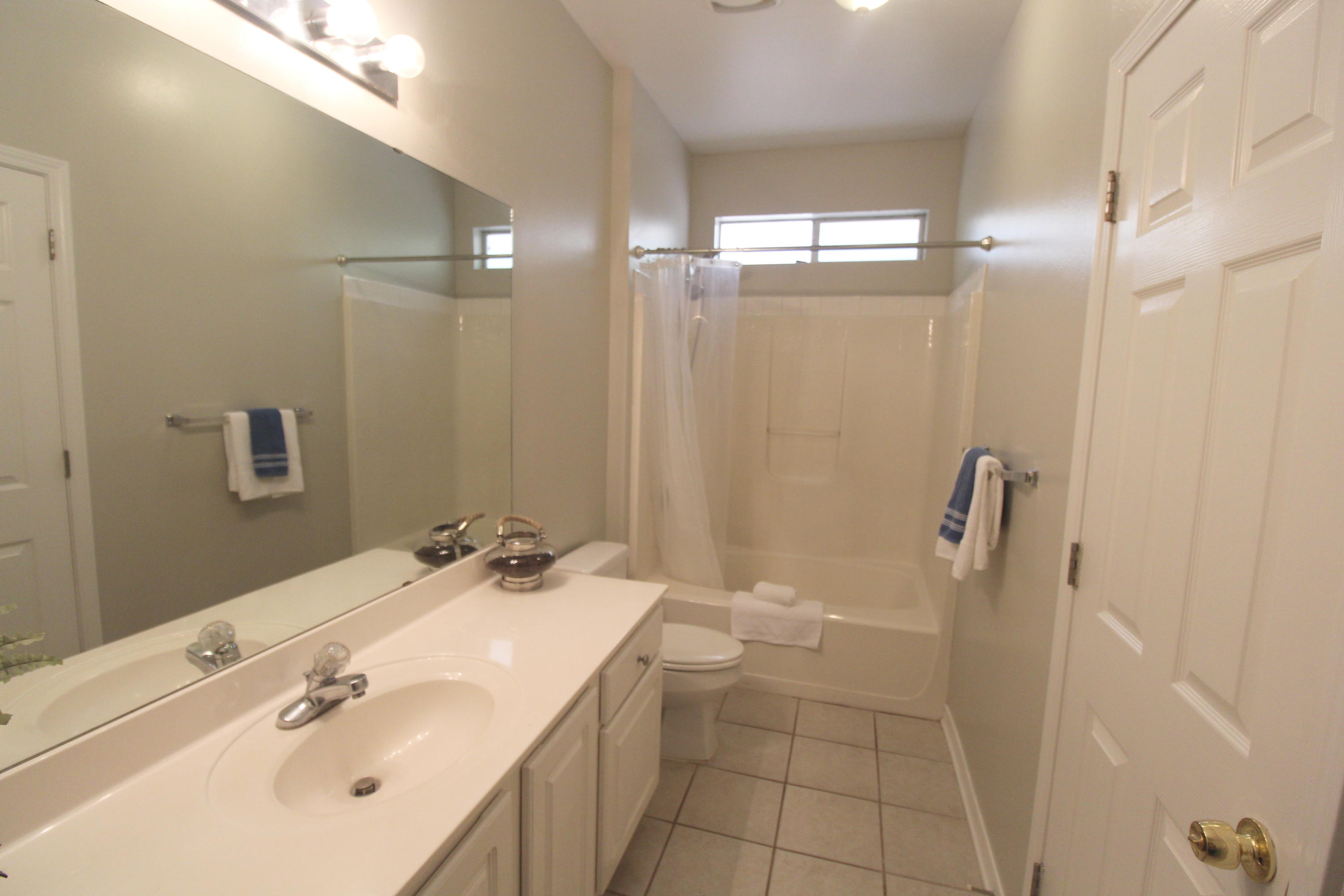 91 Walnut Street Santa Rosa Beach, FL 32459 - Photo 21 of 39 a bathroom with a sink a toilet a shower and a mirror