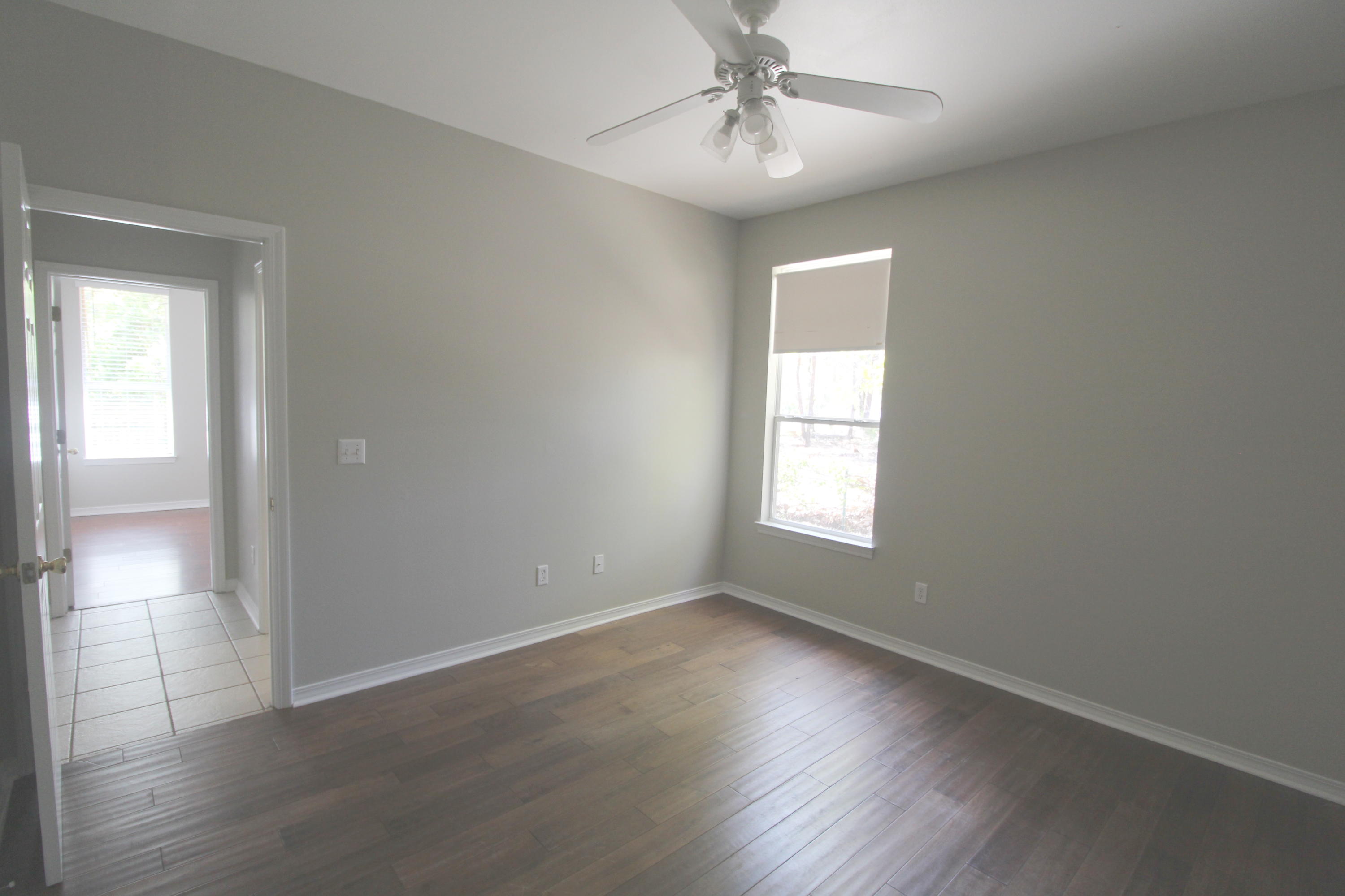 91 Walnut Street Santa Rosa Beach, FL 32459 - Photo 23 of 39 a view of an empty room with wooden floor and a window