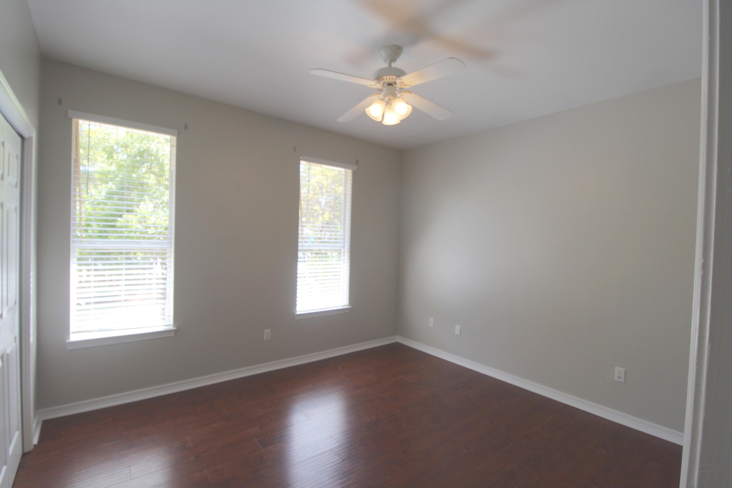 91 Walnut Street Santa Rosa Beach, FL 32459 - Photo 25 of 39 an empty room with wooden floor and windows