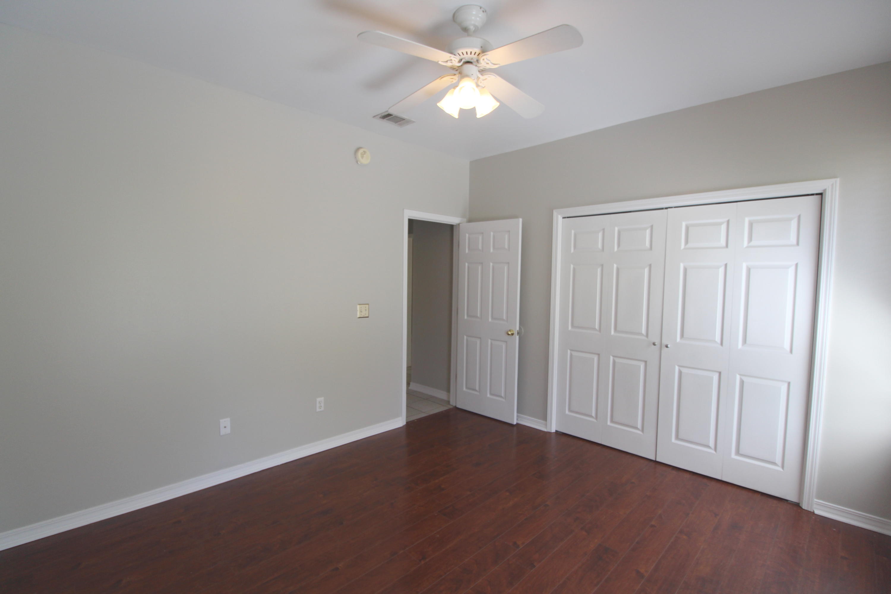 91 Walnut Street Santa Rosa Beach, FL 32459 - Photo 26 of 39 an empty room with a ceiling fan and a window