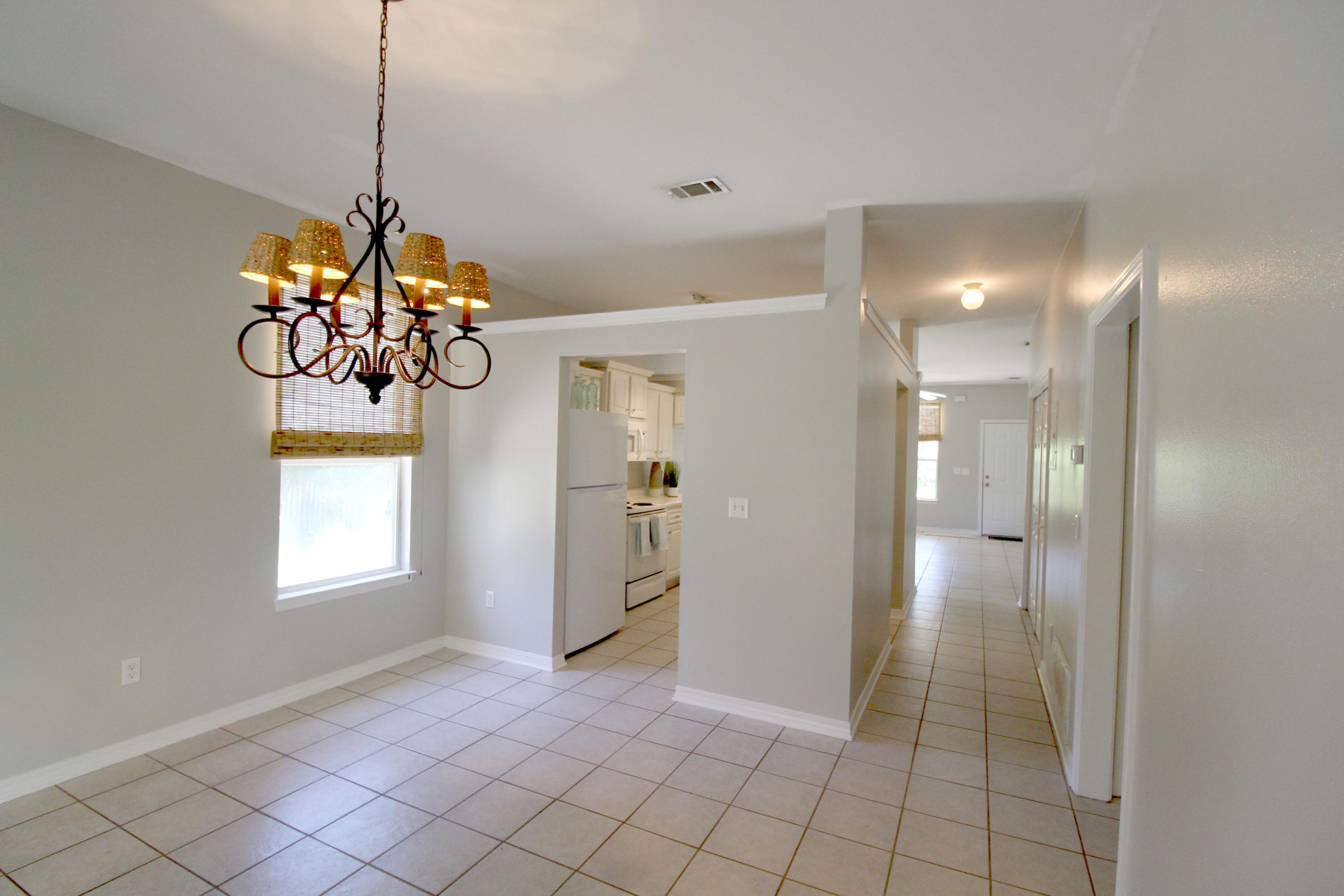 91 Walnut Street Santa Rosa Beach, FL 32459 - Photo 7 of 39 a view of a hallway with a chandelier and dining table