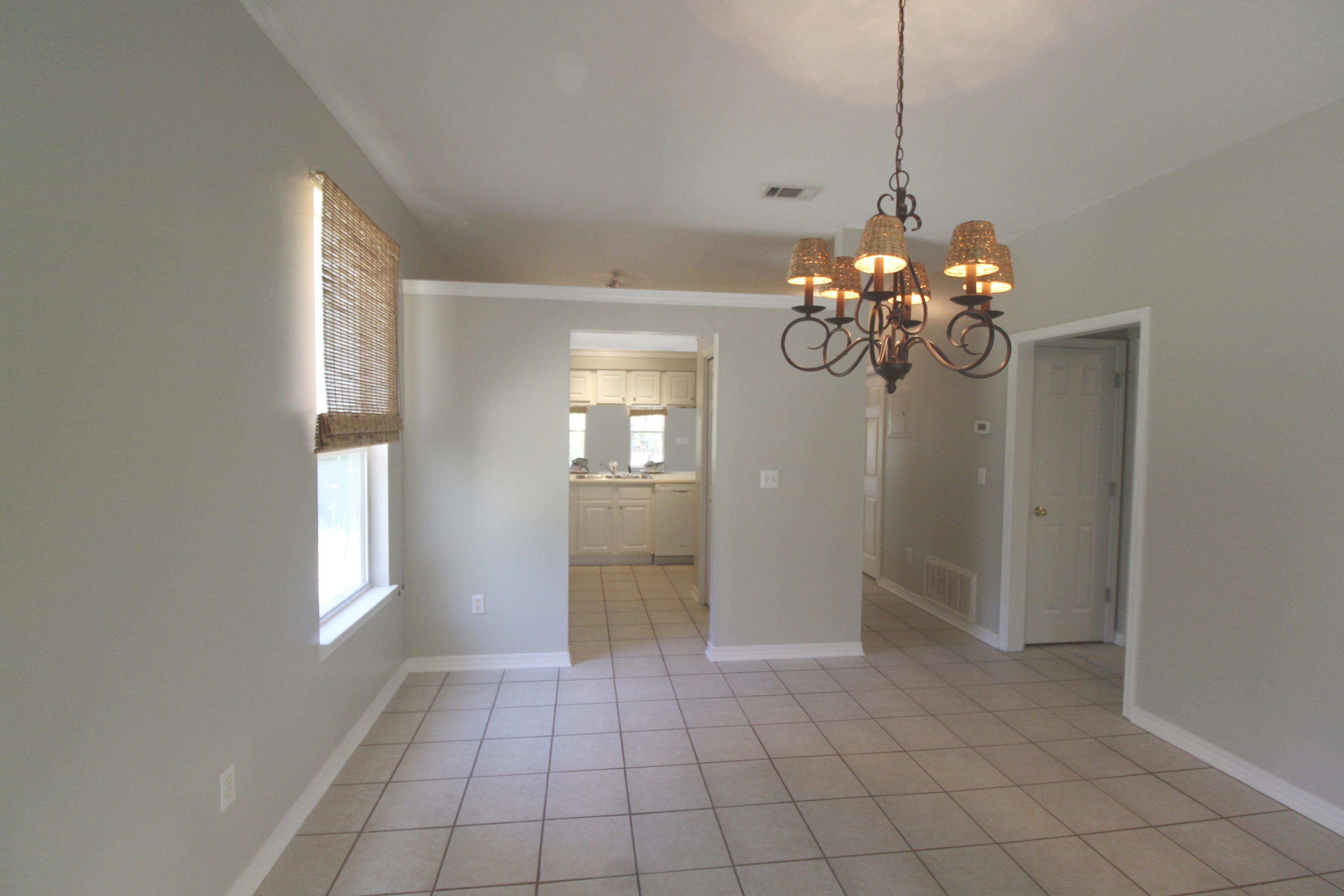 91 Walnut Street Santa Rosa Beach, FL 32459 - Photo 10 of 39 a view of an empty room with window and chandelier