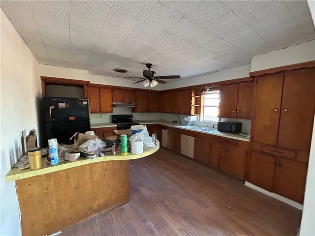 a kitchen with stainless steel appliances granite countertop a sink a stove and a refrigerator