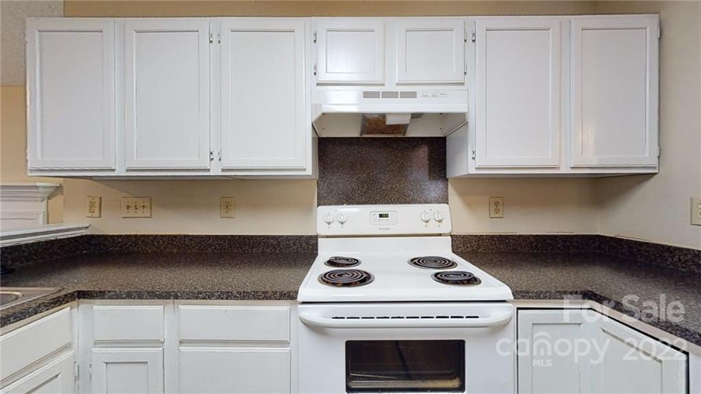 6401 Mounting Rock Road Charlotte, NC 28217 - Photo 11 of 35 a stove top oven sitting inside of a kitchen