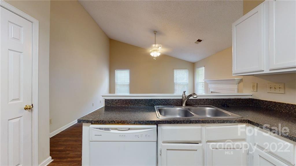 6401 Mounting Rock Road Charlotte, NC 28217 - Photo 12 of 35 a kitchen with granite countertop a sink and cabinets