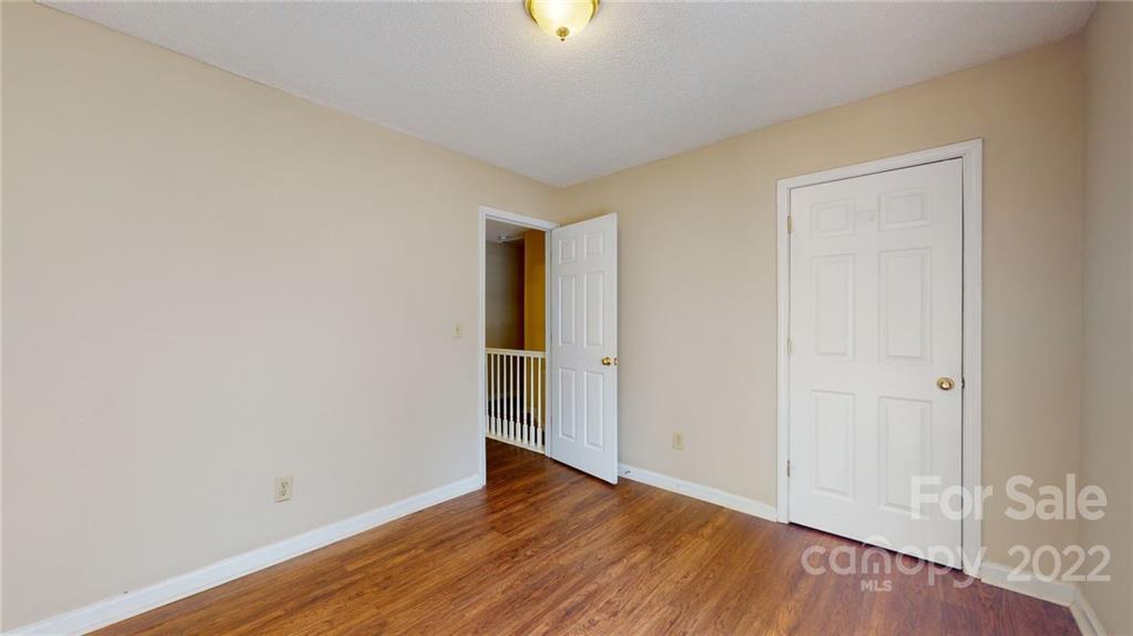6401 Mounting Rock Road Charlotte, NC 28217 - Photo 22 of 35 a view of an empty room with wooden floor