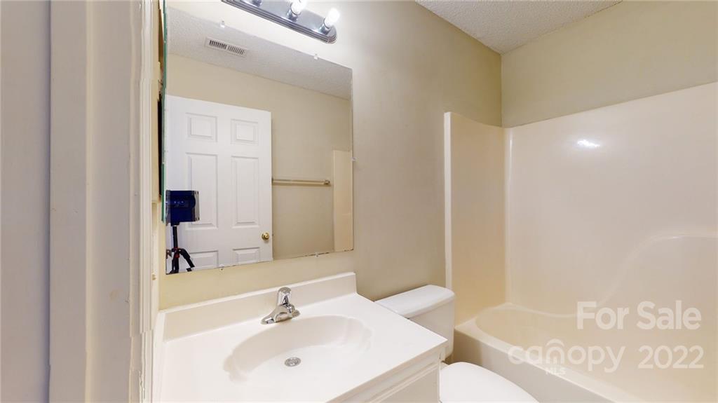 6401 Mounting Rock Road Charlotte, NC 28217 - Photo 24 of 35 a bathroom with a sink a toilet and shower