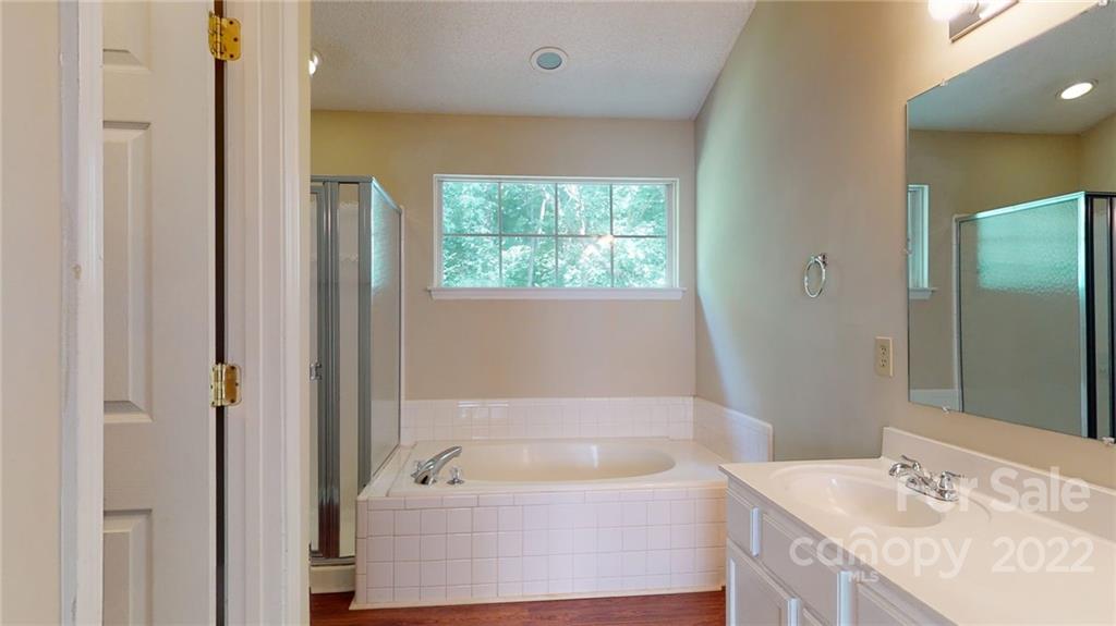 6401 Mounting Rock Road Charlotte, NC 28217 - Photo 28 of 35 a bathroom with a tub a sink and a window