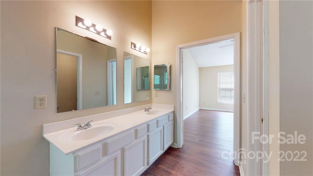 6401 Mounting Rock Road Charlotte, NC 28217 - Photo 29 of 35 a bathroom with a double vanity sink and mirror