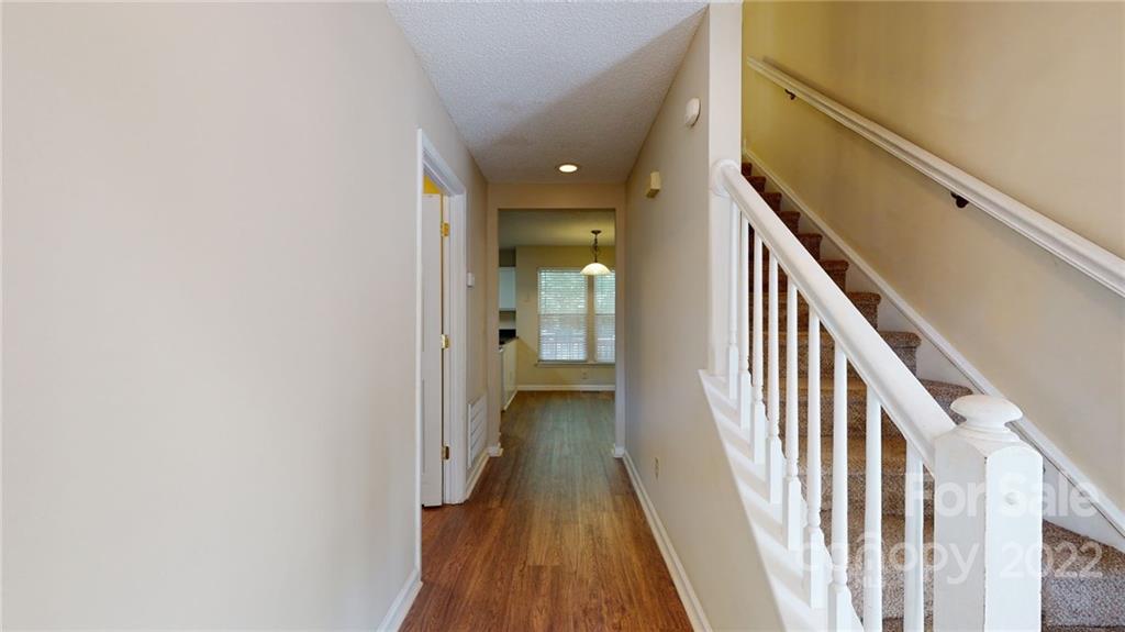 6401 Mounting Rock Road Charlotte, NC 28217 - Photo 3 of 35 a view of a hallway with wooden floor and staircase