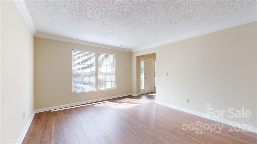 6401 Mounting Rock Road Charlotte, NC 28217 - Photo 5 of 35 an empty room with wooden floor and windows