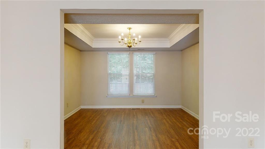 6401 Mounting Rock Road Charlotte, NC 28217 - Photo 6 of 35 a view of an empty room with wooden floor and a window