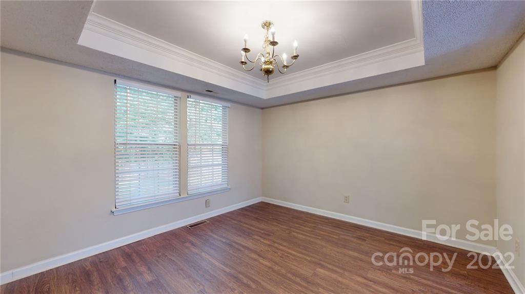 6401 Mounting Rock Road Charlotte, NC 28217 - Photo 7 of 35 a view of an empty room with window and wooden floor