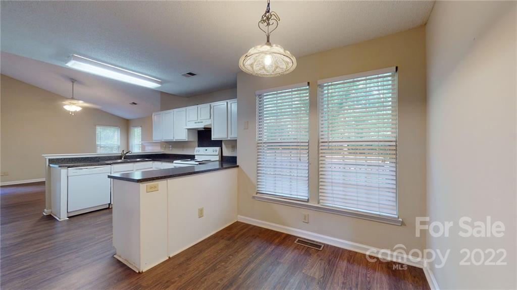 6401 Mounting Rock Road Charlotte, NC 28217 - Photo 8 of 35 a kitchen with stainless steel appliances granite countertop a sink a stove and a wooden floors