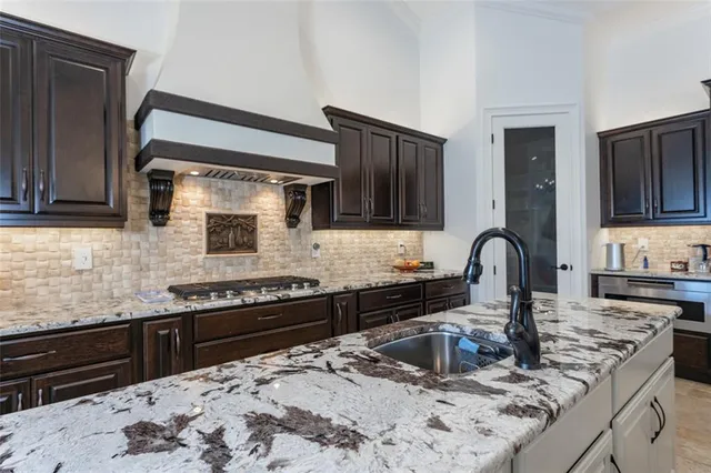 a bathroom with a granite countertop sink a toilet a mirror and shower