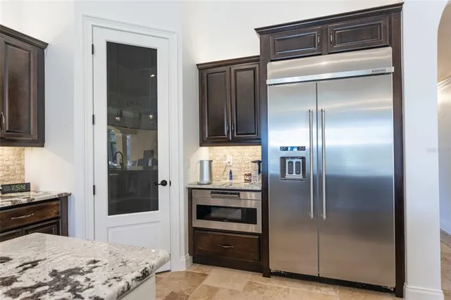 a bathroom with a granite countertop sink a toilet and a mirror