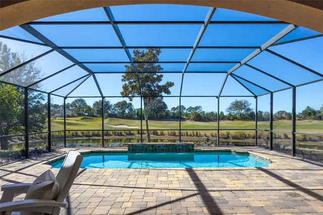 a living room with furniture a fireplace and a large mirror with wooden floor