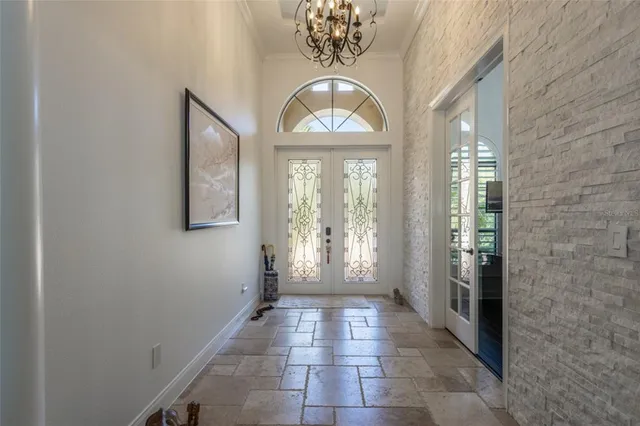 a dining room with furniture a chandelier and window