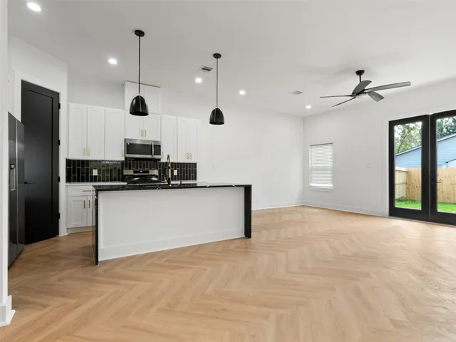 a view of kitchen with a sink and a refrigerator