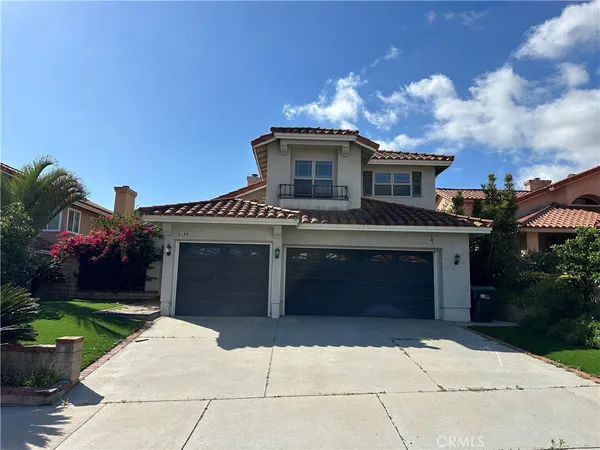 a front view of a house with yard