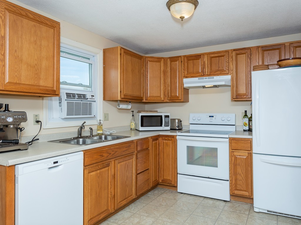 24 North Farms Road Williamsburg, MA 01039 - Photo 15 of 40 a kitchen with a sink stove and cabinets
