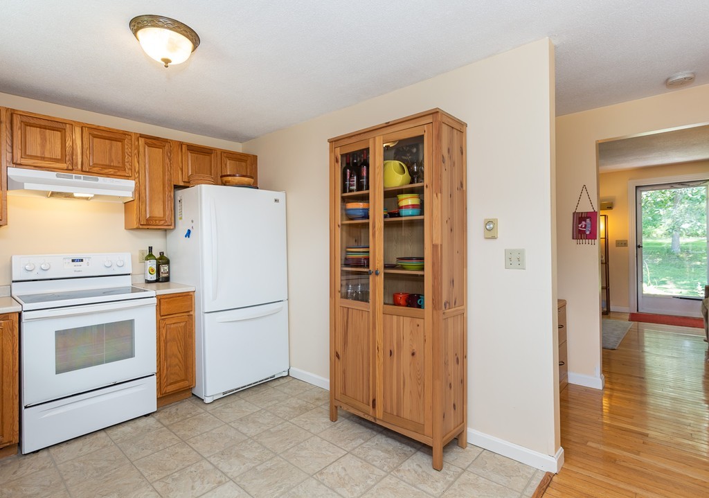24 North Farms Road Williamsburg, MA 01039 - Photo 16 of 40 a kitchen with a refrigerator and a stove
