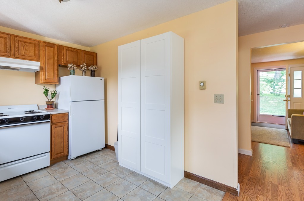 24 North Farms Road Williamsburg, MA 01039 - Photo 31 of 40 a kitchen with a refrigerator and a stove