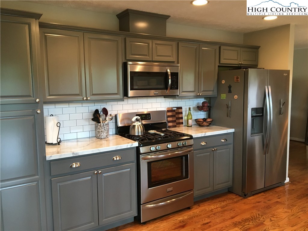 172 Deer Street Boone, NC 28607 - Photo 3 of 7 a kitchen with stainless steel appliances granite countertop a stove a refrigerator and a sink