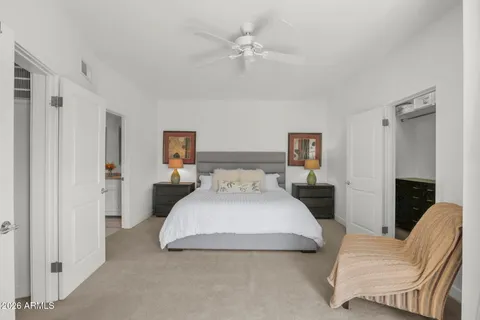 a bedroom with a bed couch and a window