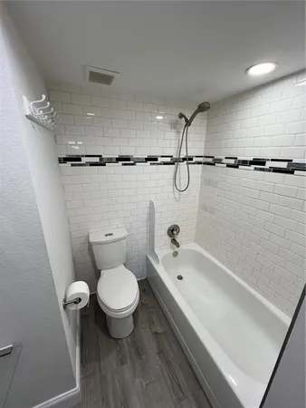 a bathroom with a toilet and a tub