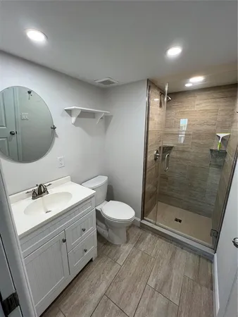 a bathroom with a double vanity sink toilet and shower
