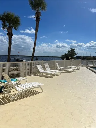 a view of swimming pool with a table under an umbrella