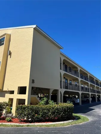 a front view of a building with a garden
