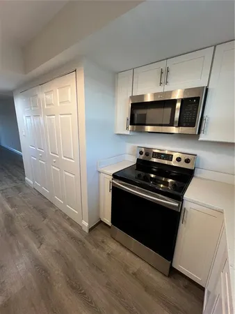 a kitchen with a stove and a microwave