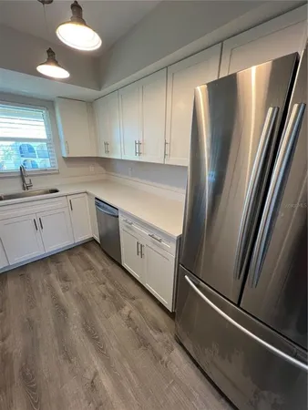 a kitchen with a refrigerator and a sink