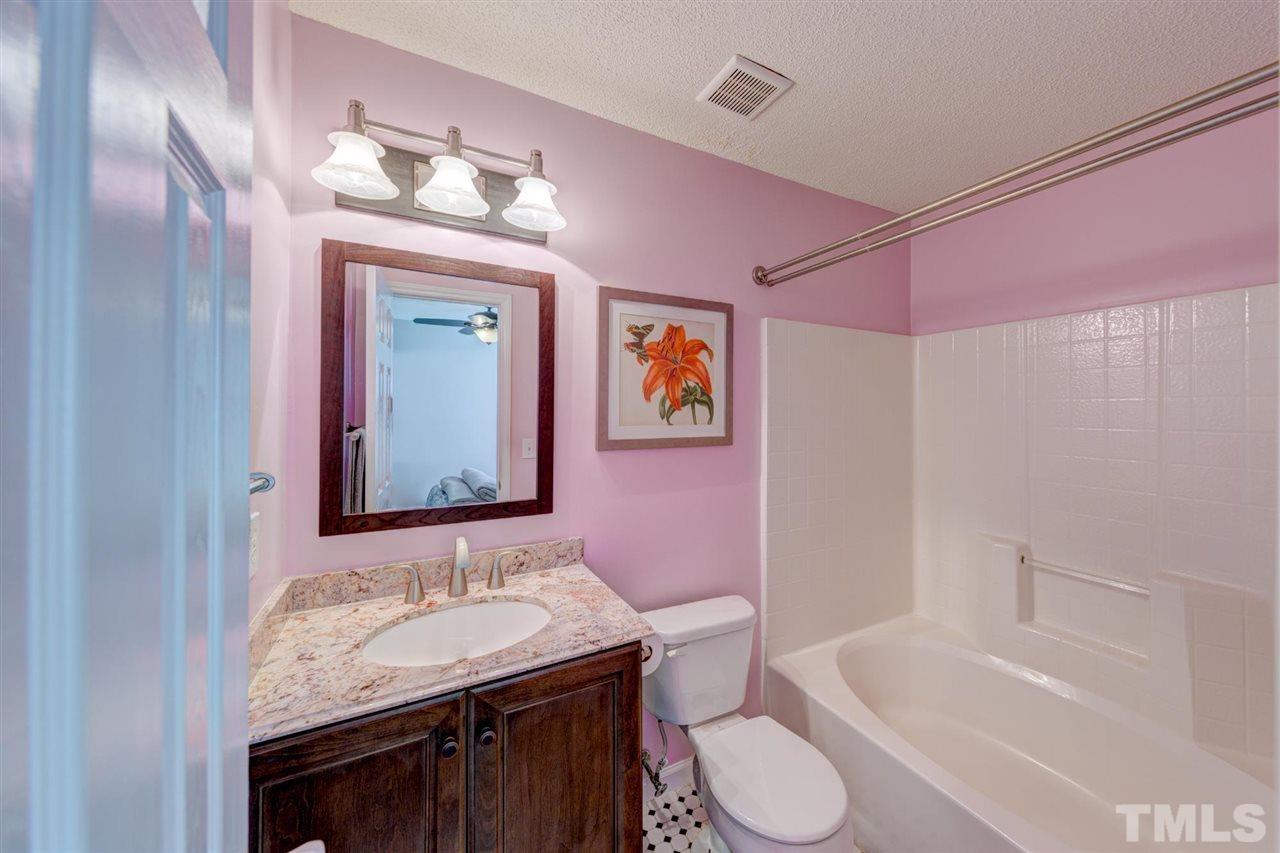 4845 Silverdene Street Raleigh, NC 27616 - Photo 11 of 24 a bathroom with a granite countertop sink and a mirror