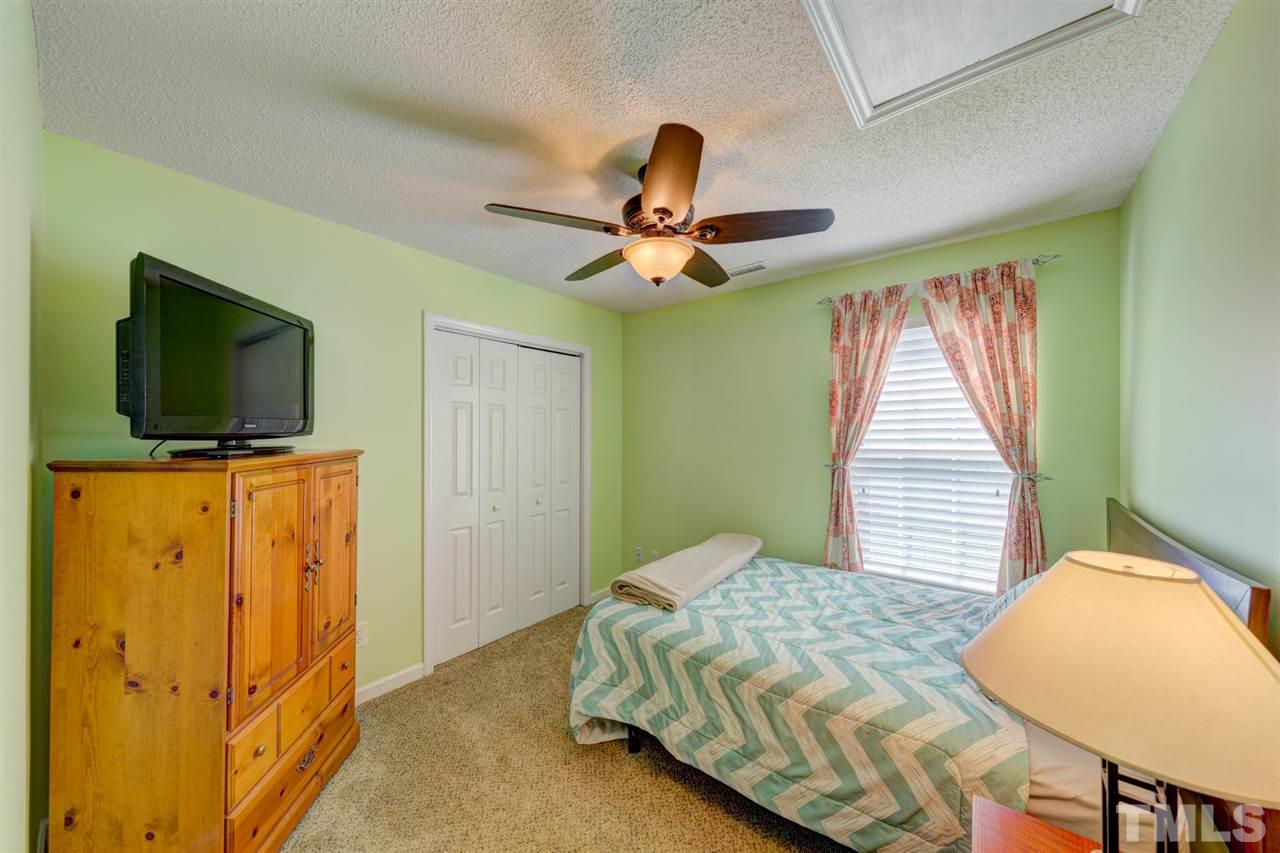 4845 Silverdene Street Raleigh, NC 27616 - Photo 13 of 24 a bedroom with a bed and a flat screen tv