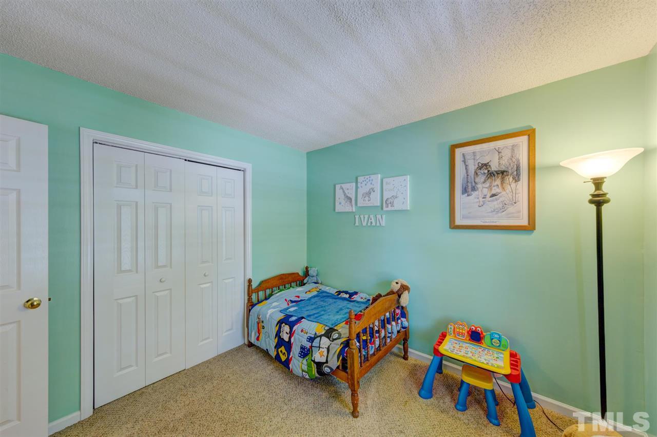 4845 Silverdene Street Raleigh, NC 27616 - Photo 15 of 24 a bedroom with a bed and a window