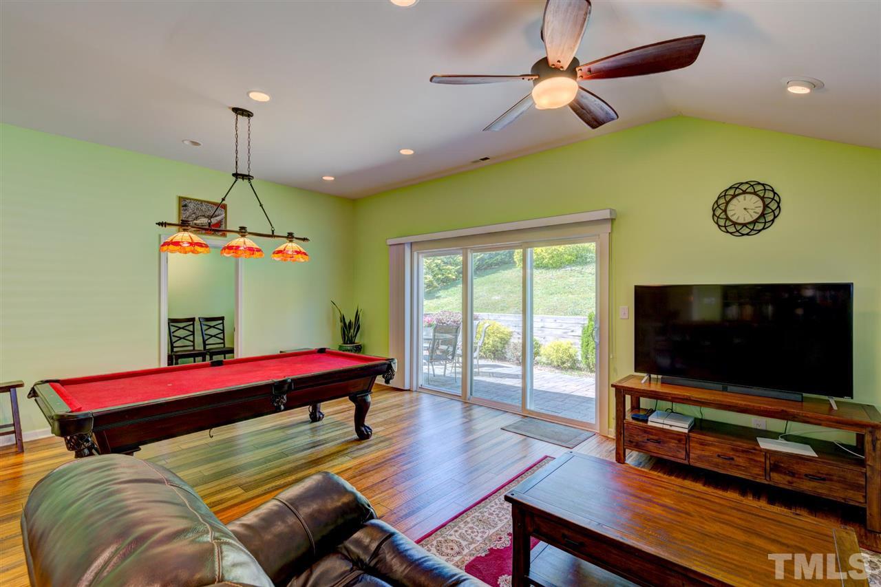 4845 Silverdene Street Raleigh, NC 27616 - Photo 16 of 24 a living room with furniture and a flat screen tv