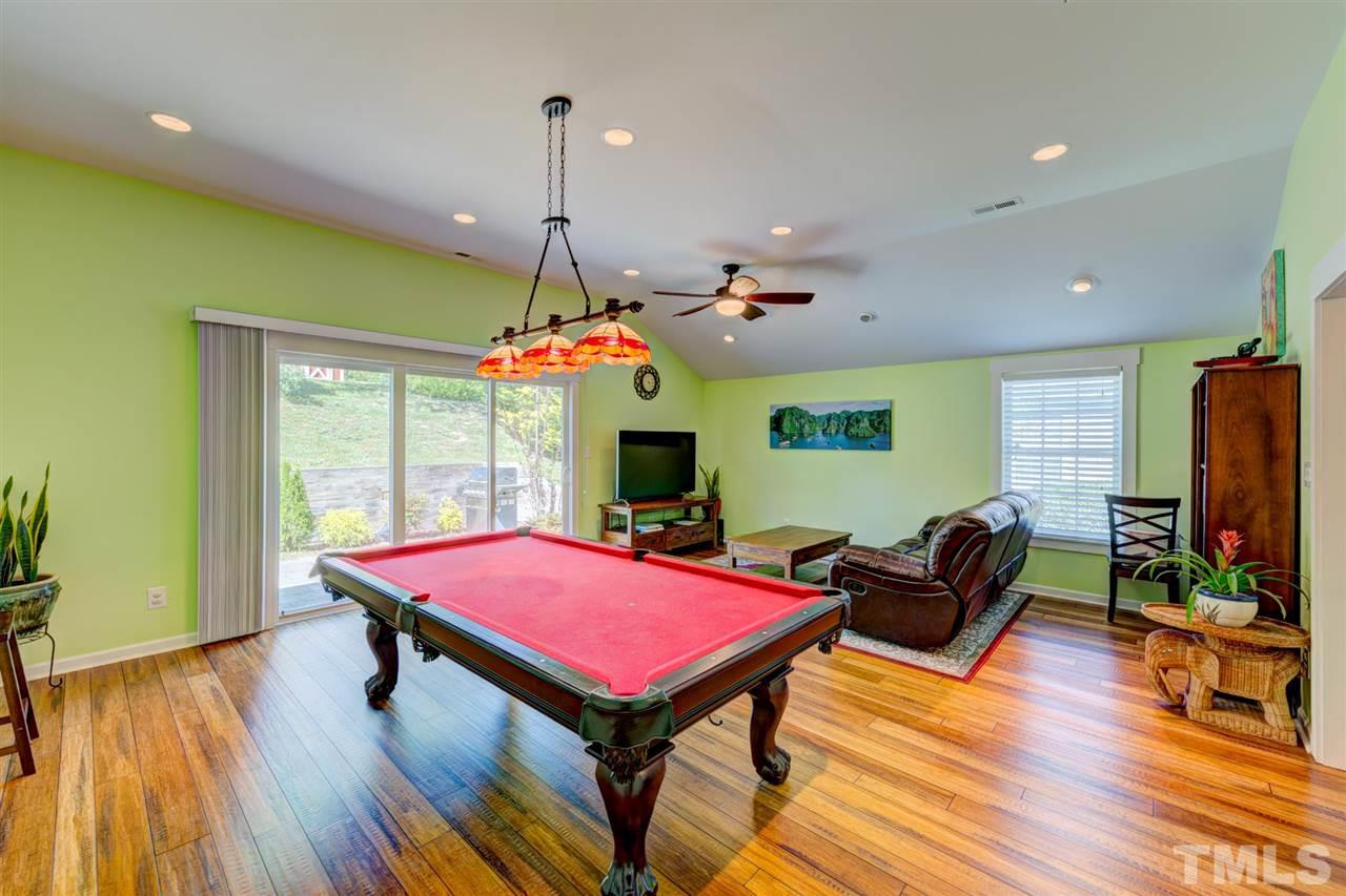 4845 Silverdene Street Raleigh, NC 27616 - Photo 17 of 24 a living room with furniture pool table flat screen tv and a large window