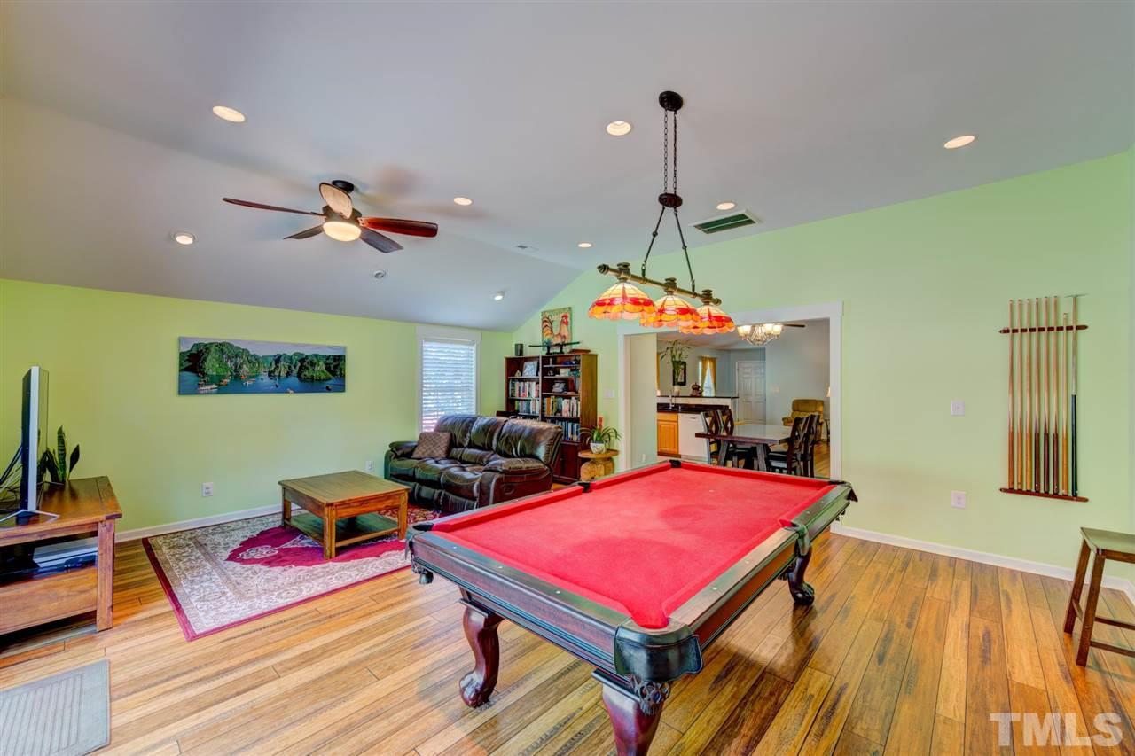 4845 Silverdene Street Raleigh, NC 27616 - Photo 18 of 24 a living room with pool table and a flat screen tv