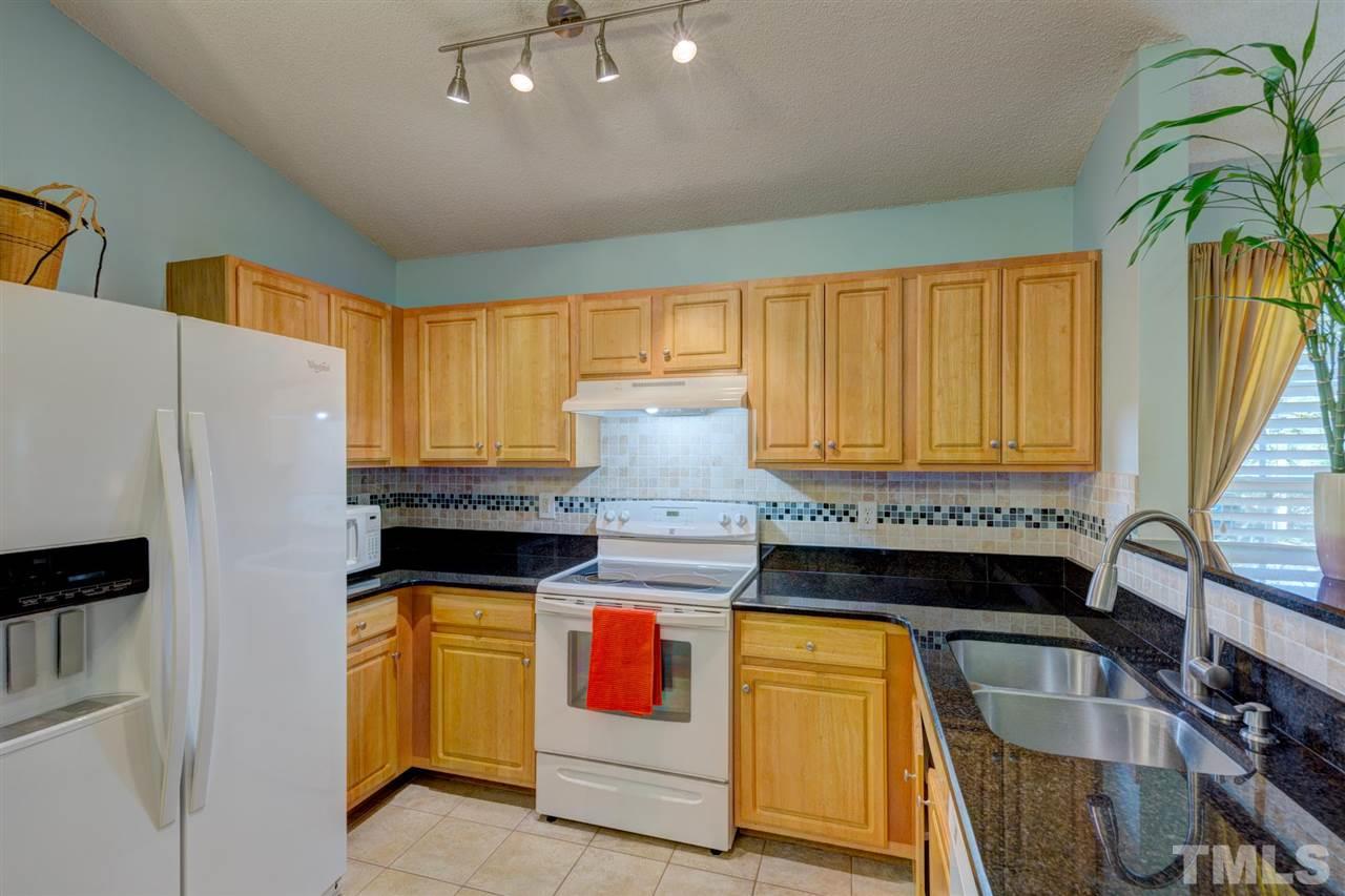 4845 Silverdene Street Raleigh, NC 27616 - Photo 5 of 24 a kitchen with stainless steel appliances granite countertop a stove and a refrigerator